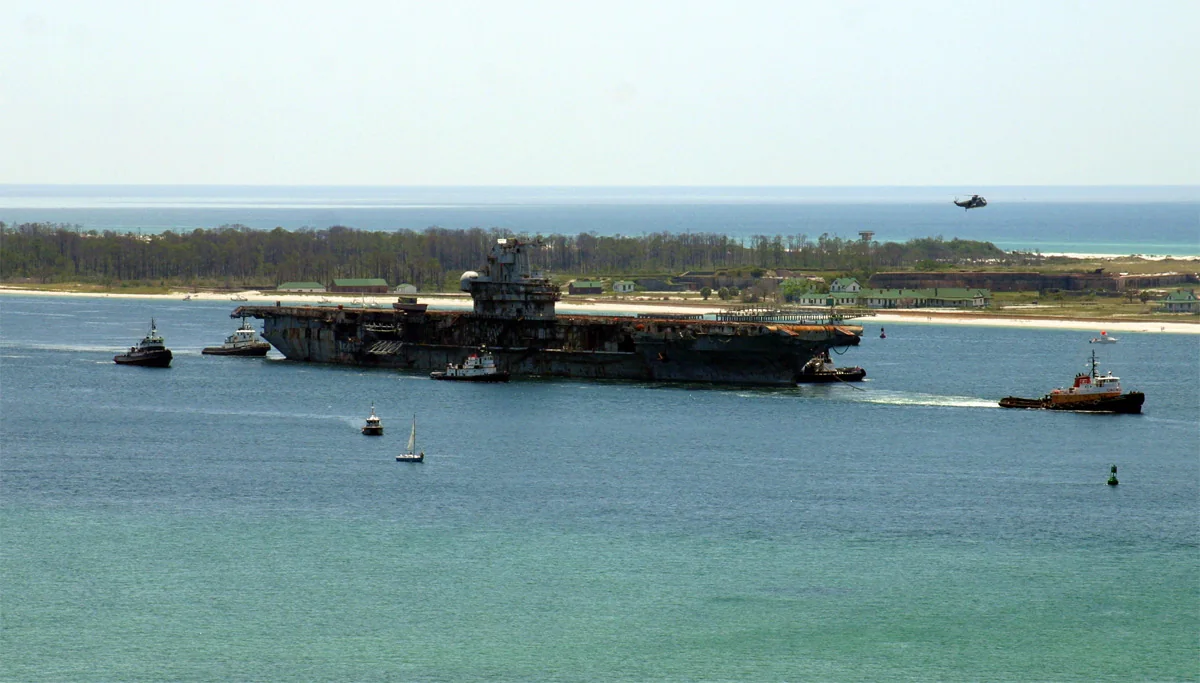Former USS Oriskany being towed out of Pensacola in May 2006